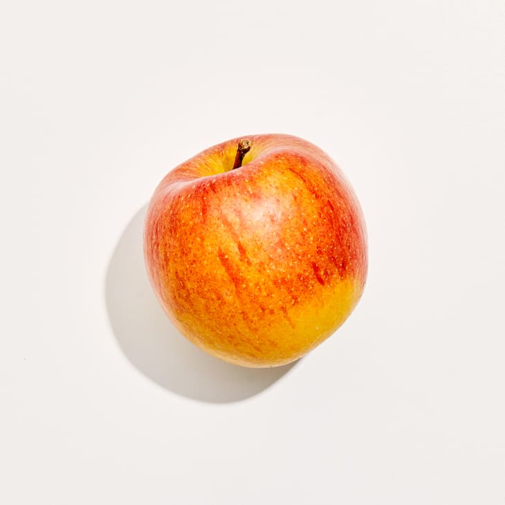 Overhead photo of a Braeburn apple on a white background