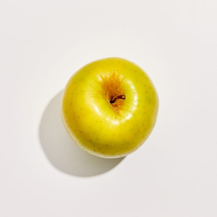 Overhead photo of a Golden Delicious apple on a white background