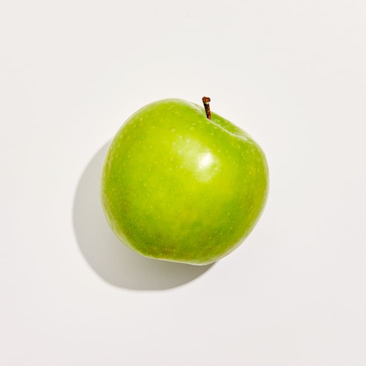 Overhead photo of a Granny Smith apple on a white background