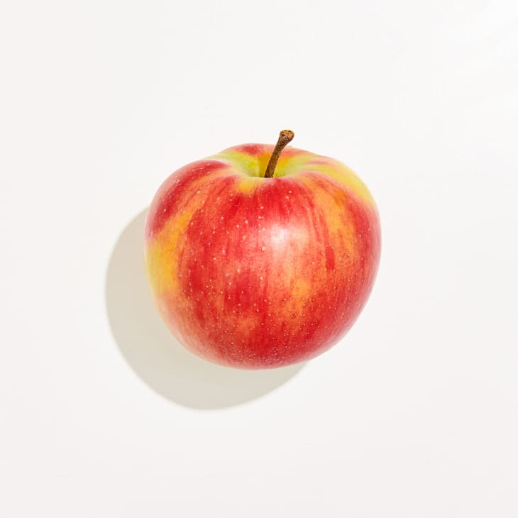 Overhead photo of a Jonagold apple on a white background