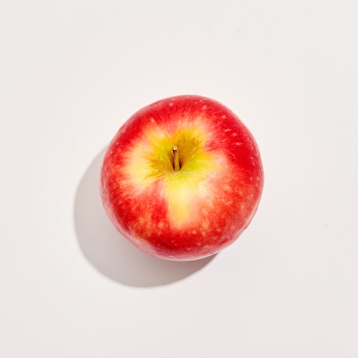 Overhead photo of a Pink Lady apple on a white background