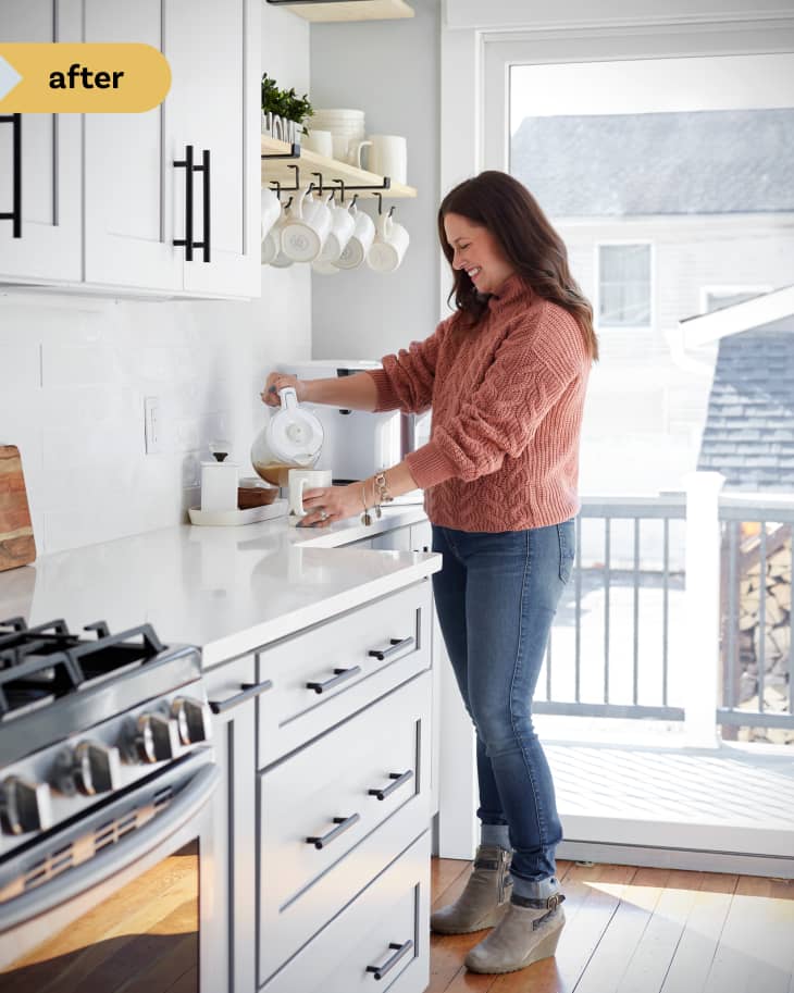 Alicia Ragonese pouring coffee in renovated kitchen.