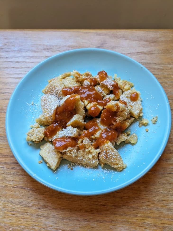 pile of pastry on blue plate with drizzled red sauce