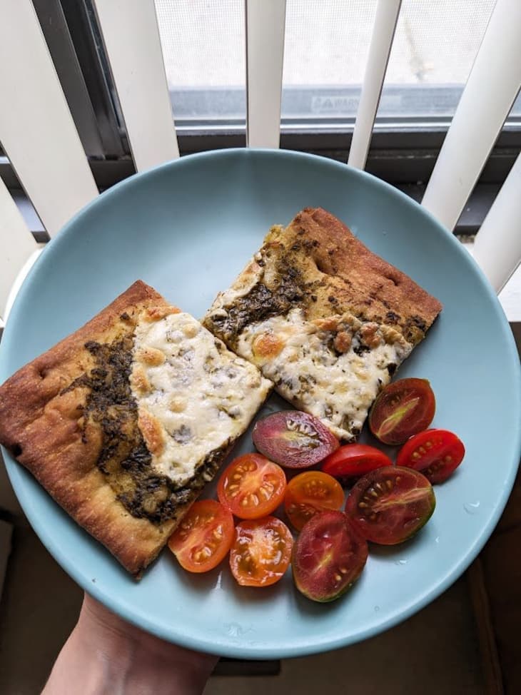 blue plate with a flat bread and cherry tomatoes