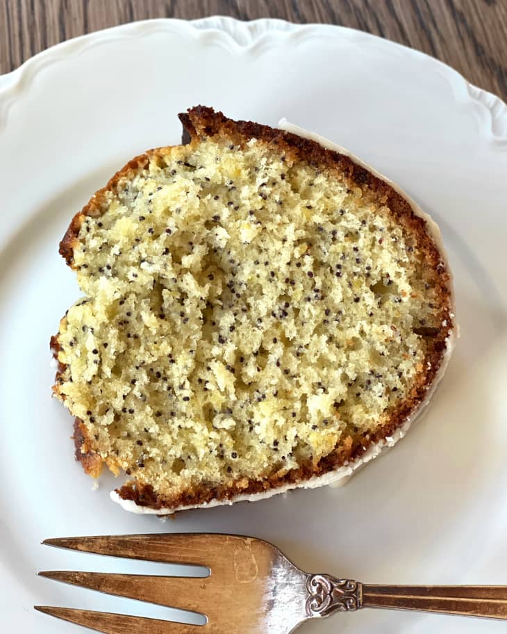 slice of lemon poppyseed cake on a plate with a fork