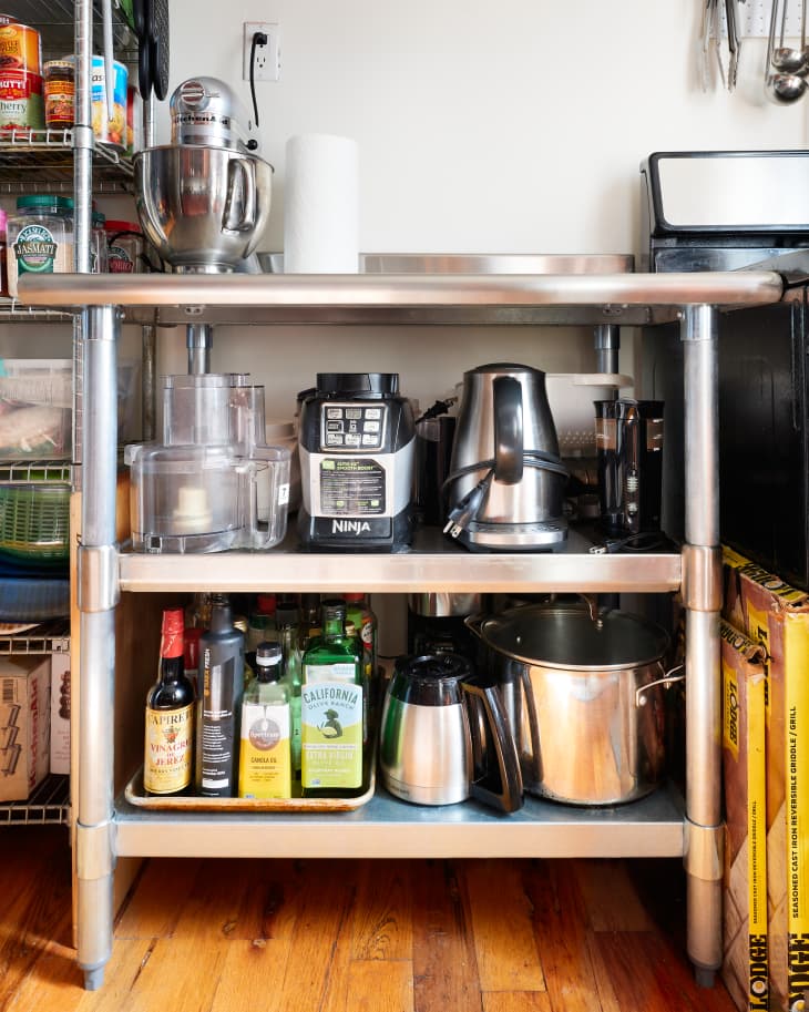 Organized kitchen appliances and pantry items on shelf
