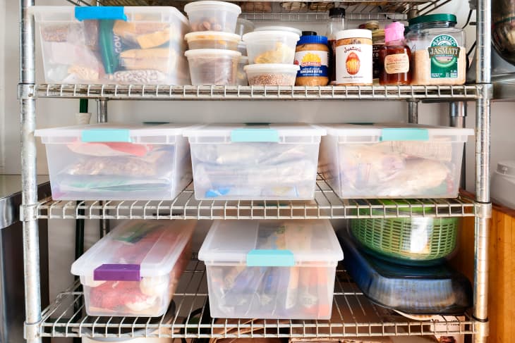 Organized plastic food storage containers in kitchen