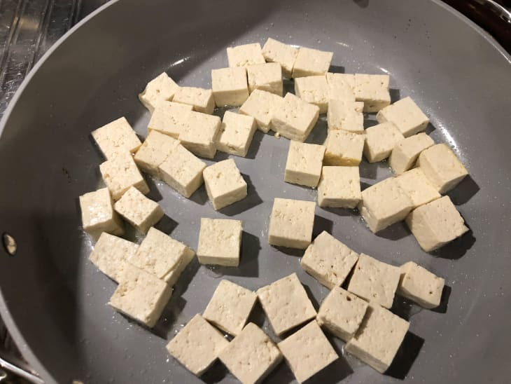 raw tofu in caraway saute pan