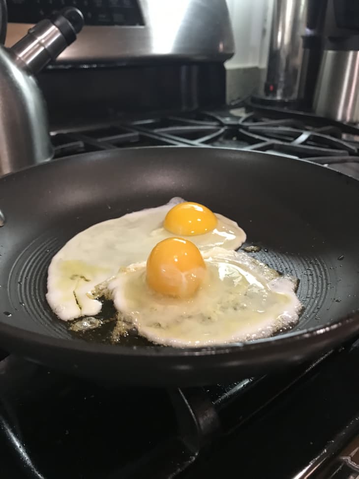 two eggs cooking in skillet
