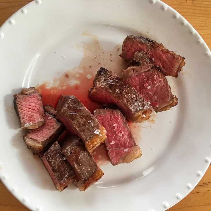 steak sits on a plate, cut and ready to eat