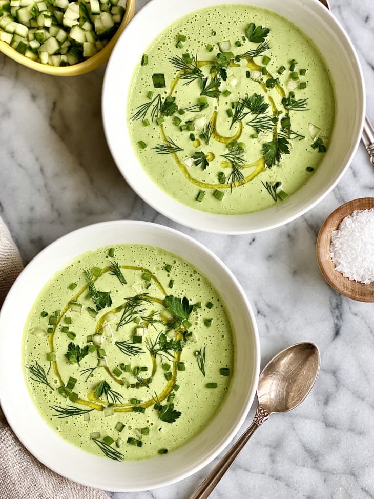 bowls of cucumber soup with spoon and salt