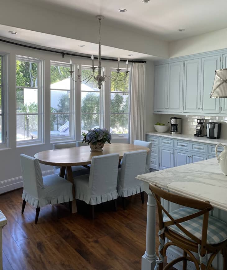 dining table in kitchen with powder blue chairs and cabinets