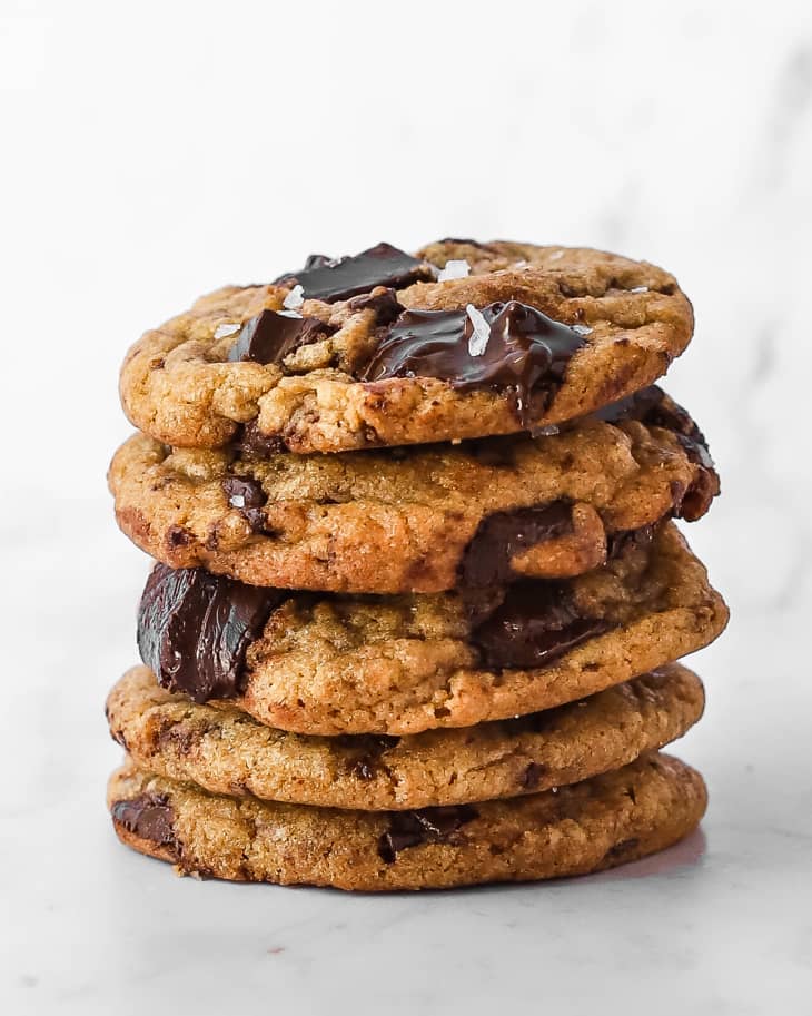 Photograph of brown butter chocolate chip cookies stacked into a pile.