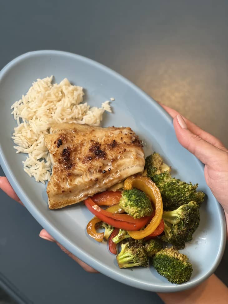 sablefish, rice, broccoli, and peppers on a plate