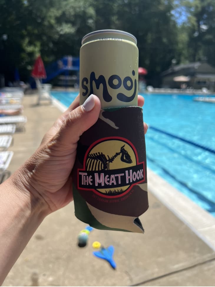 hand holding Smooj by the pool