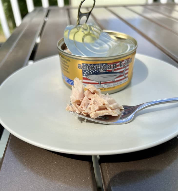 American Tuna can on plate next to tuna on fork