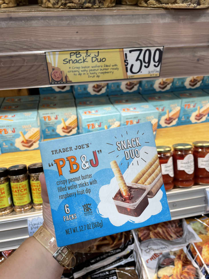 hand holding PB&amp;J snack duo next to $3.99 price tag