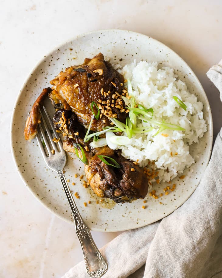 Chicken Adobo with rice on a white plate.
