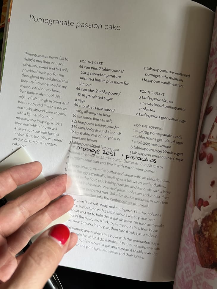 hand adding a note on a transparent post-it on a cookbook page