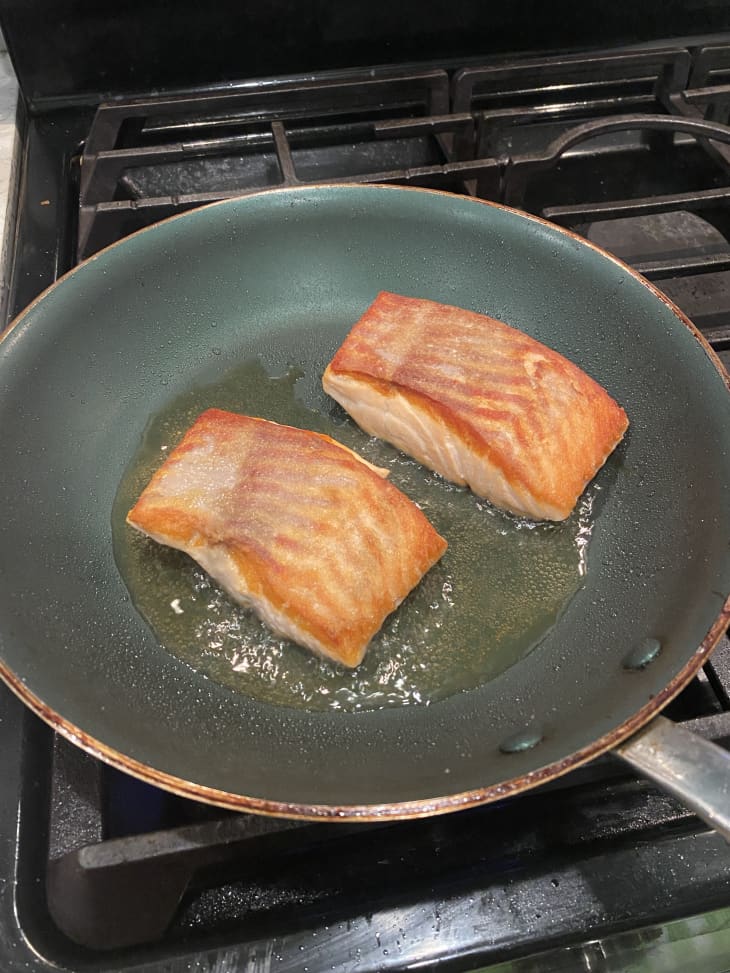 salmon filets searing in pan