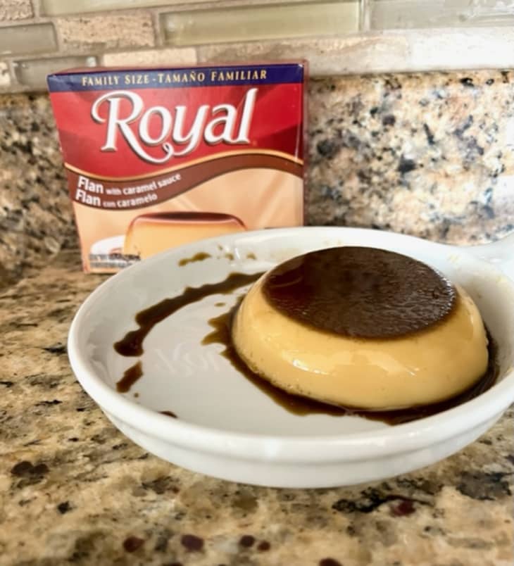 flan on white plate, Royal box behind plate
