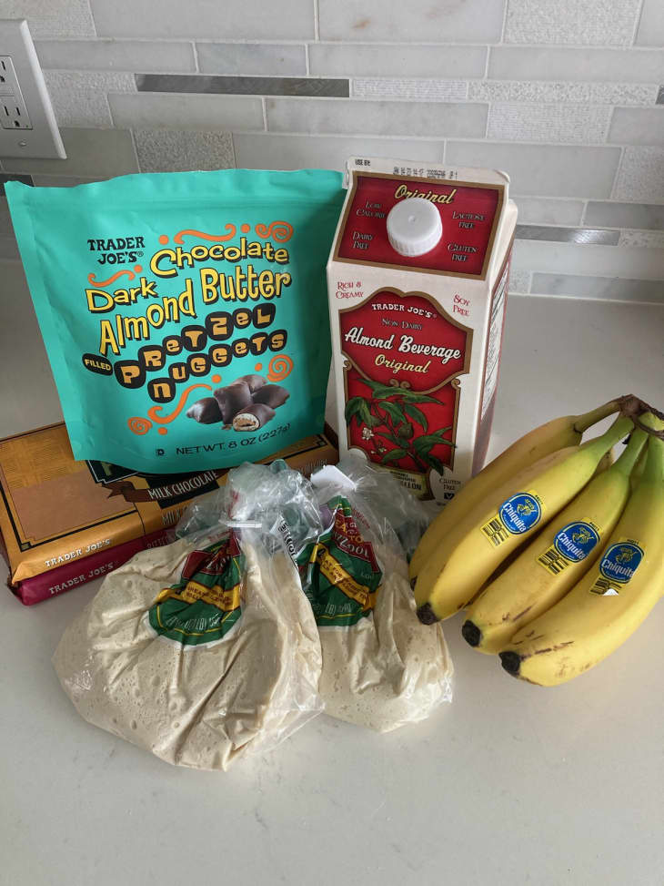 groceries from Trader Joe's - almond butter pretzel nuggets, almond beverage, pizza dough, bananas, chocolate