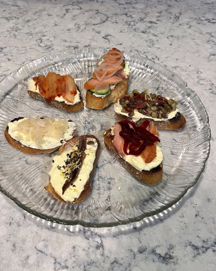 glass platter with 6 toasts, all with vodka butter spread, each with different toppings