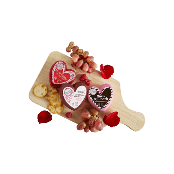 cheese board with cheeses, rose petals, crackers and fruit from aldi