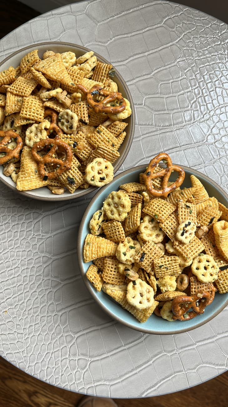 Two bowls of furikake chex mix on surface.