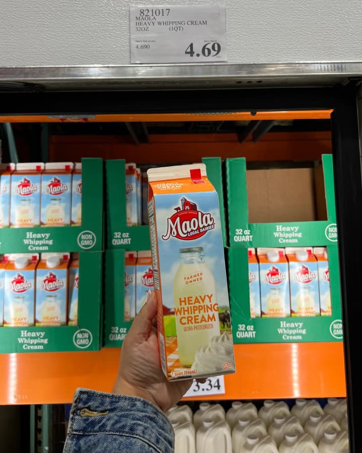 A carton of Maola Heavy Whipping Cream being held up for the camera in a Costco store