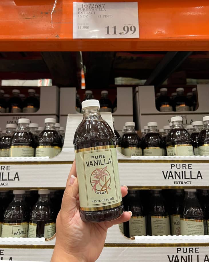 A bottle of pure vanilla extract being held up for the camera in a Costco store