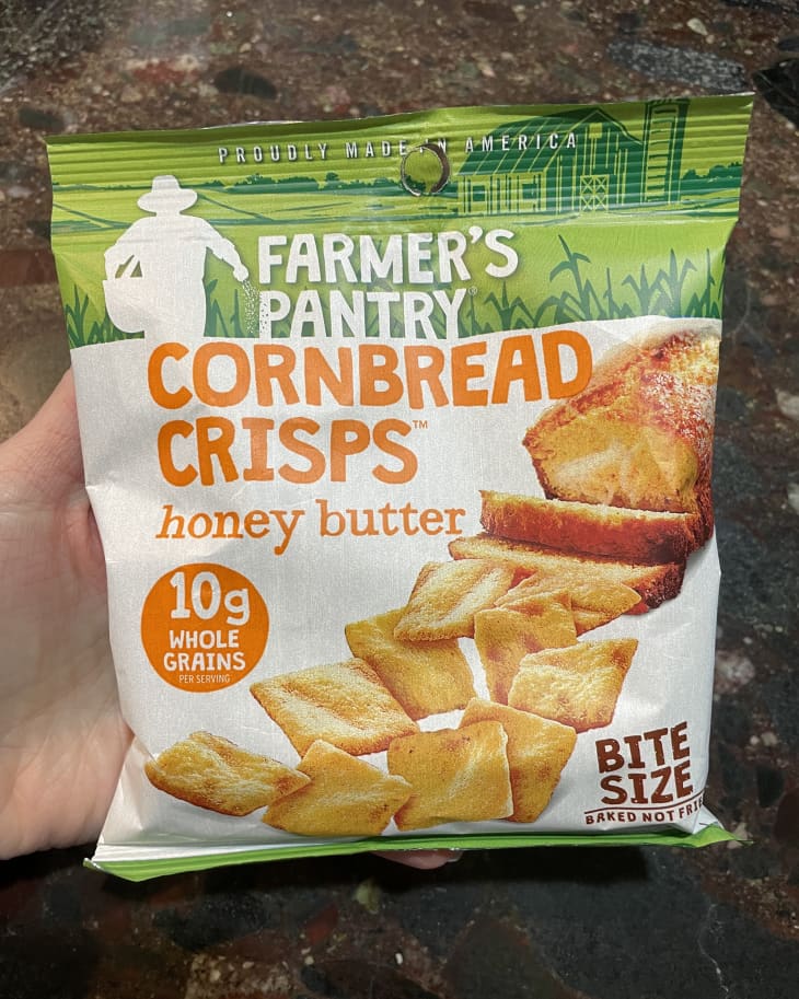 someone holding package of Farmer's Pantry Cornbread Crisps (honey butter flavor)