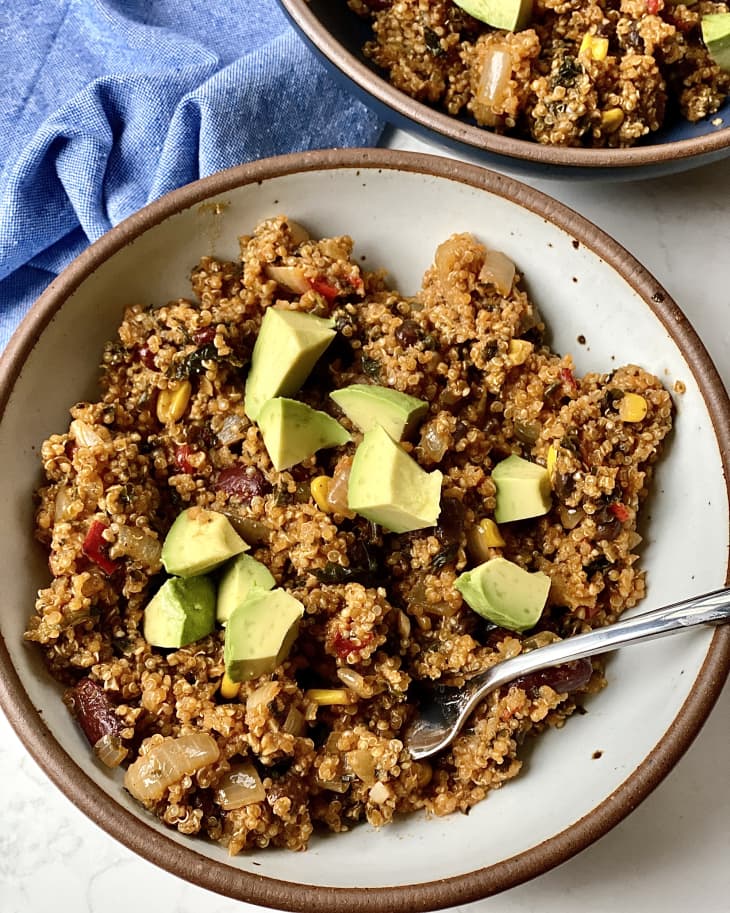 Caribbean-Style Beans and Greens Quinoa Skillet, 2 servings in ceramic bowls with avocado