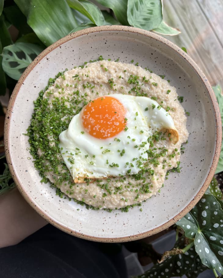 Fried sunnyside up egg over cooked oat bran with chives