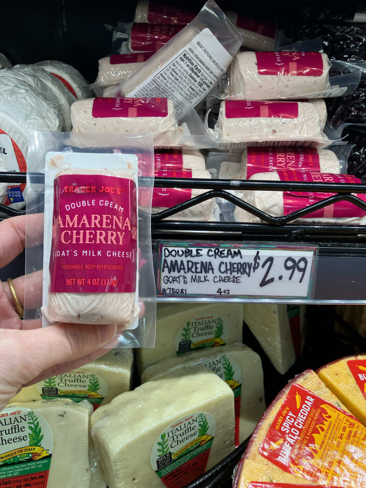 Someone holding package of Trader Joe's Amarena Cherry goat cheese.