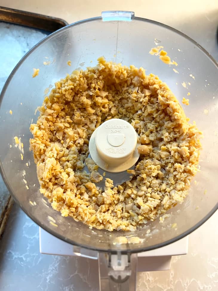 Chickpeas in food processor after being blended.