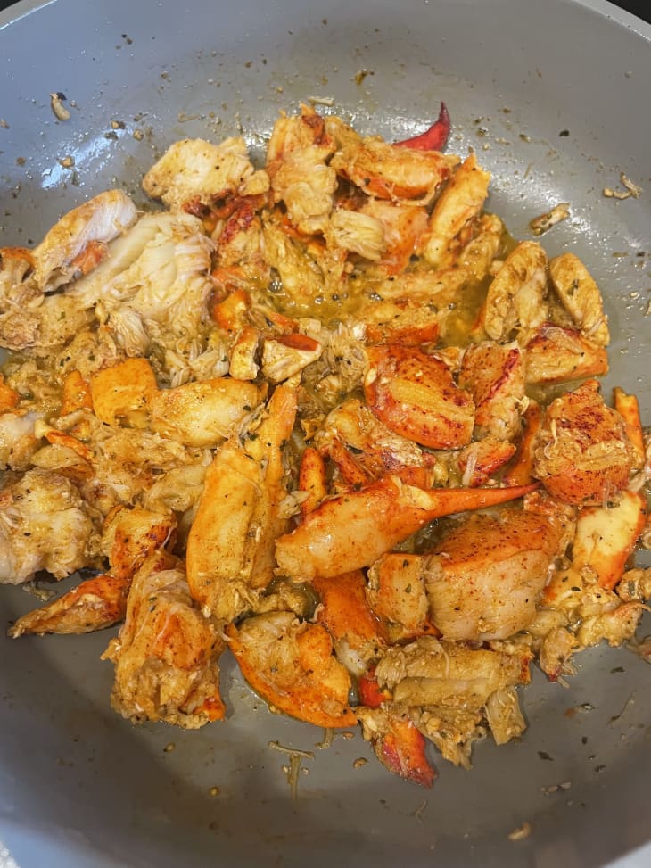 Lobster meat cooking in skillet.