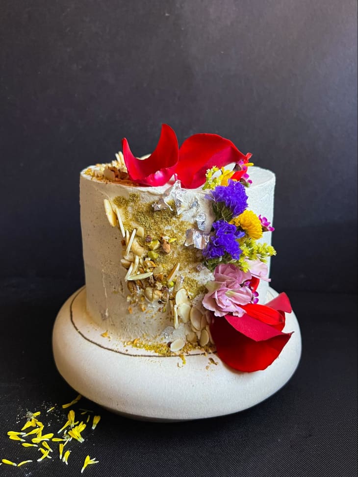 Decorated Thandai layer cake on stand.
