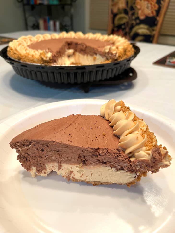 Slice of Costco peanut butter pie on plate with remaining pie in background.