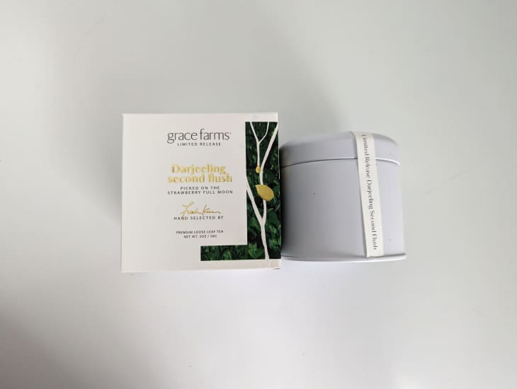 Grace farms Darjeeling tea in packaging on white background.