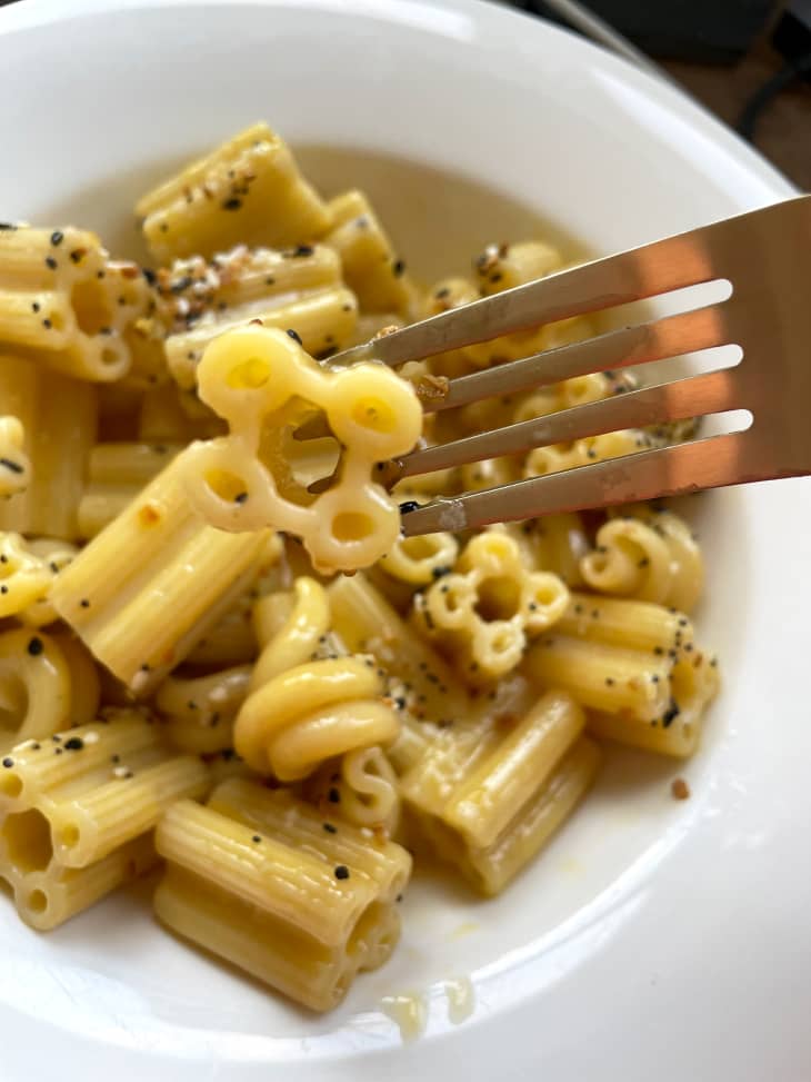 Prepared Sfoglini pasta on fork and some in bowl.