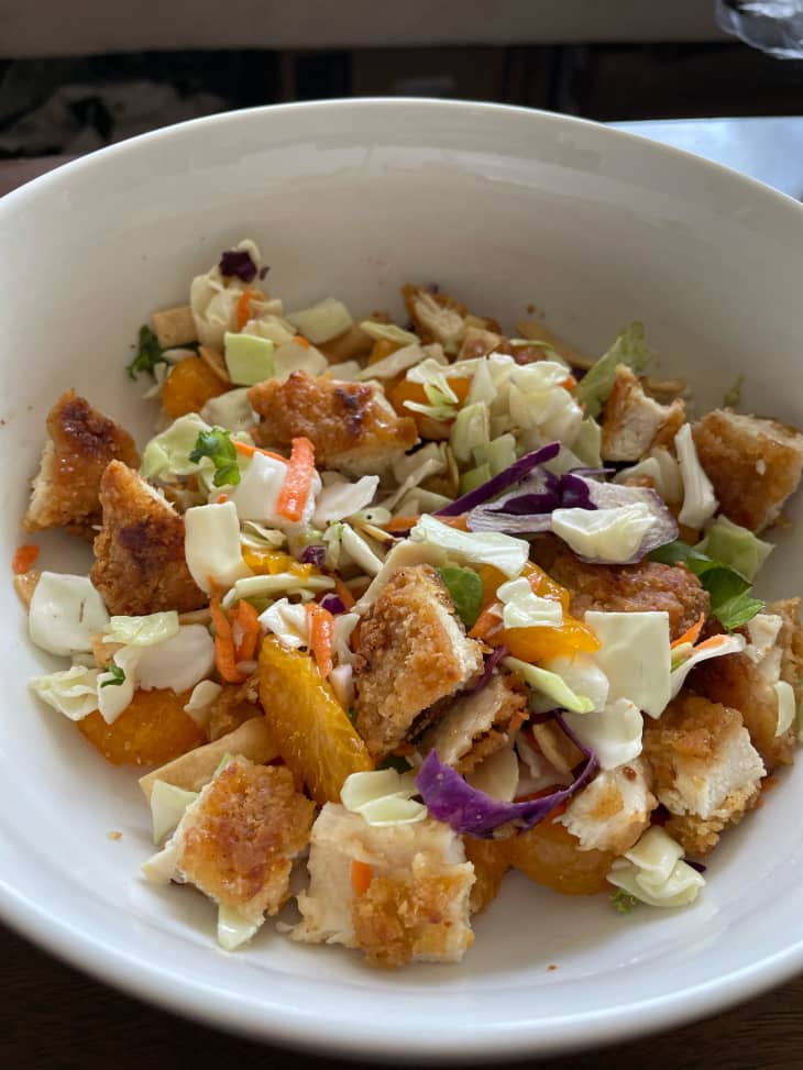 Three ingredient Aldi salad with pieces of breaded chicken breast on top.