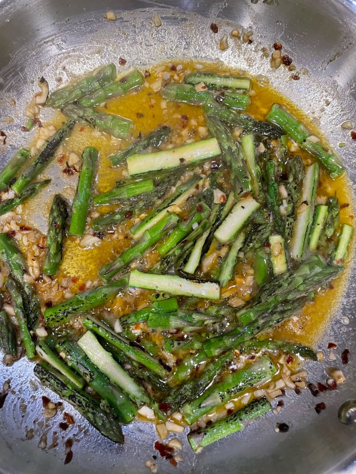 Asparagus cooking in skillet.