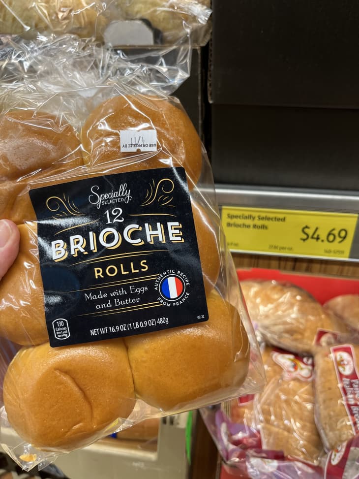 Someone holding package of brioche buns in Aldi's grocery store.