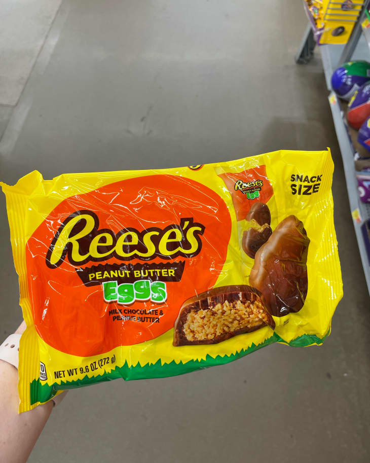 Someone holding package of Reese's peanut butter eggs.