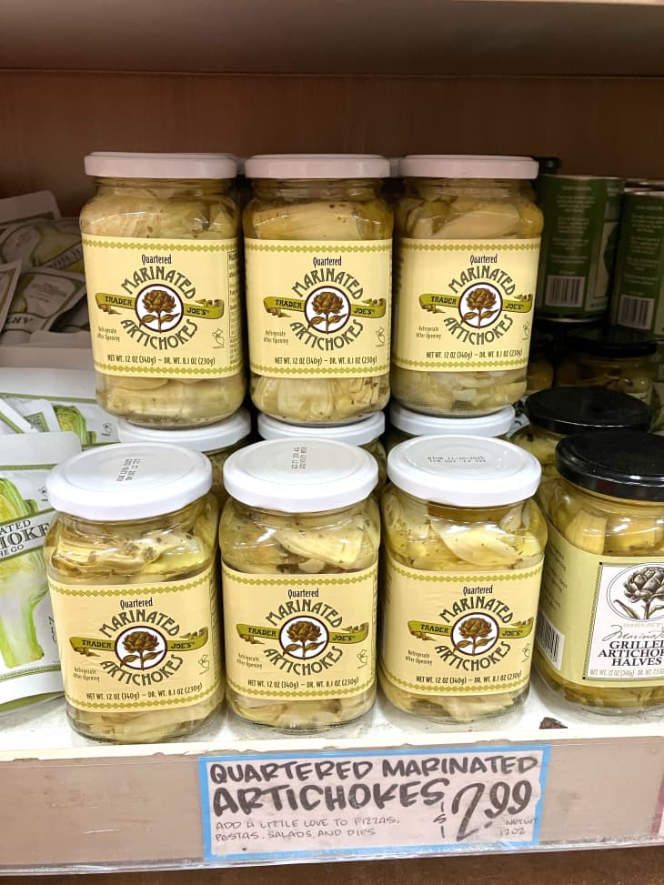 Trader Joe's marinated artichokes stacked in jars in store.