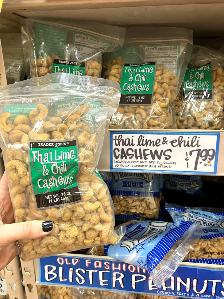 Someone holding package of Trader Joe's Thai lime and chili cashews.
