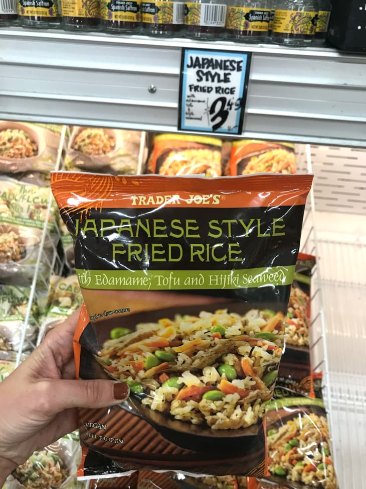 Someone holding Trader Joe's Japanese style fried rice.