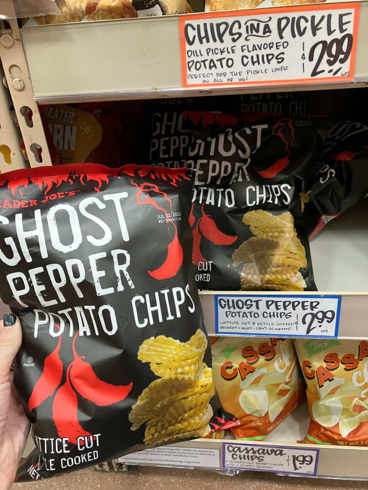 Someone holding Trader Joe's Ghost Pepper potato chips.