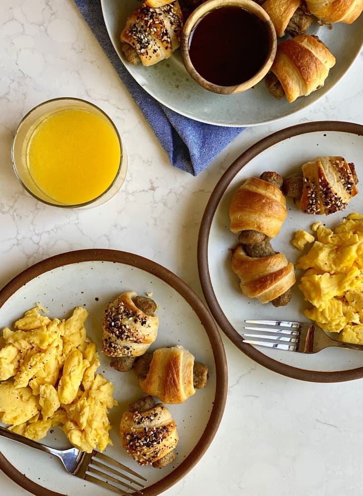 Breakfast pigs in a blanket with eggs on the side.